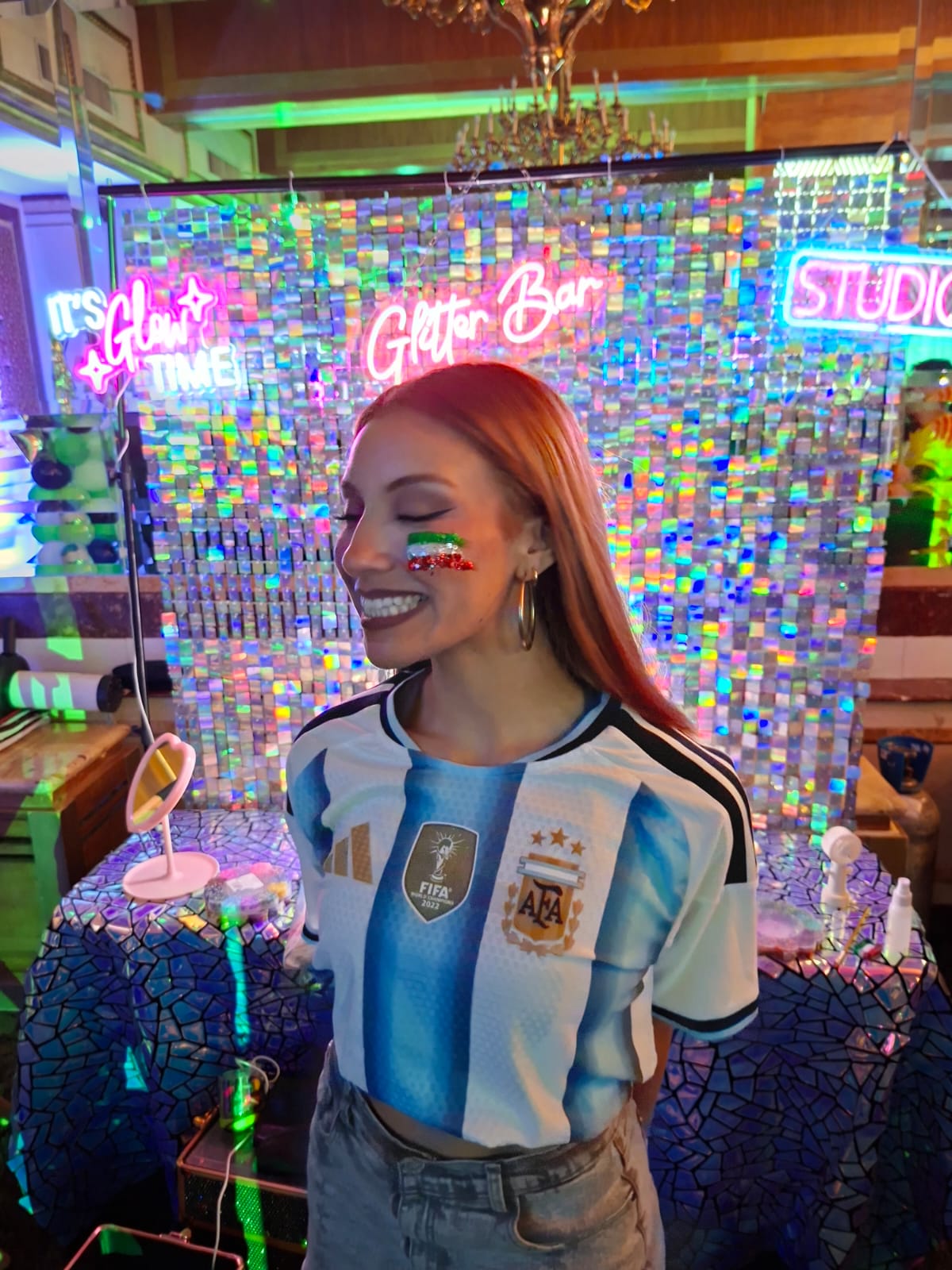 Invitada con maquillaje de colores frente al Glitter Bar